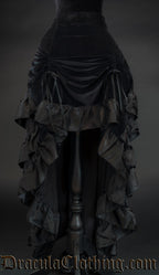 Women's black layered bustle skirt made with velvet and satin shown with front raised by two ribbons