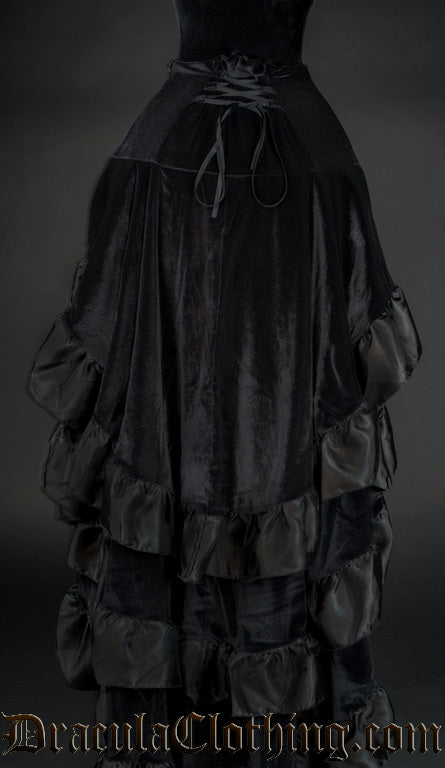 Back view of women's velvet black layered bustle skirt showing corset style lacing for adjustments
