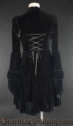 Back view of black velvet women's dress showing adjustable corset style lacing in the torso