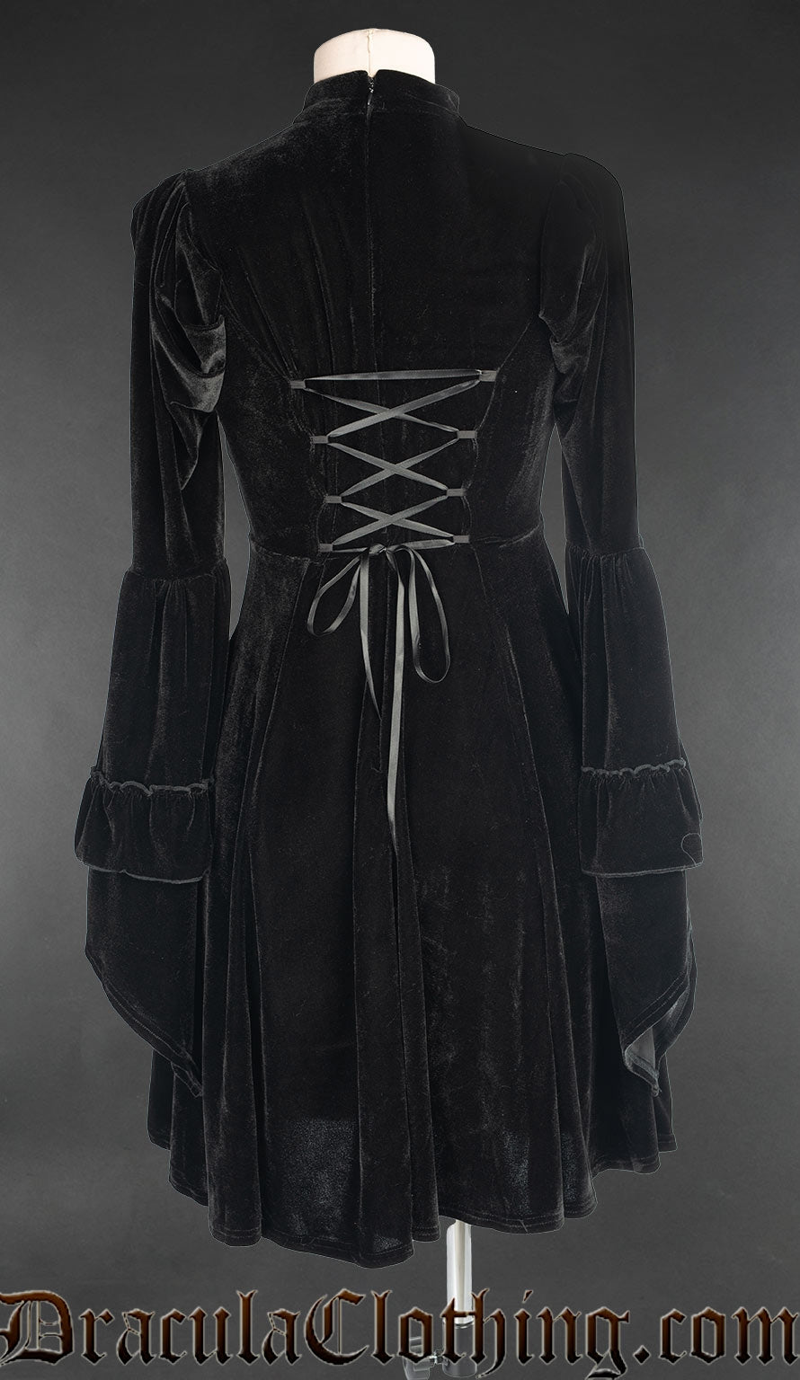 Back view of black velvet women's dress showing adjustable corset style lacing in the torso