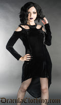 Model wearing black velvet long sleeved dress with cold shoulder cut-outs