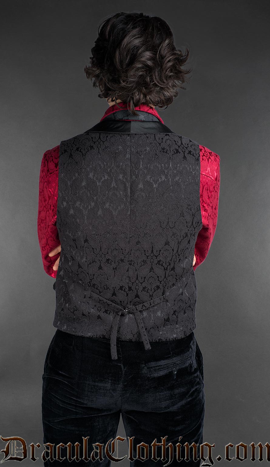Back view of Victorian black cotton brocade gothic double-breasted waistcoat over red brocade shirt
