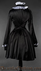 Back view of Gothic Victorian maid dress with black satin, long sleeves, and white ruffle details
