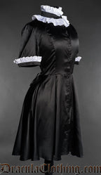 Victorian gothic dress in black satin with white ruffled collar and cuffs angled side view
