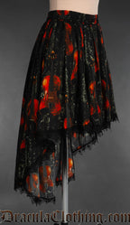 Side view of violin print women's black skirt with elastic waist showing high low hem short in front and long in the back