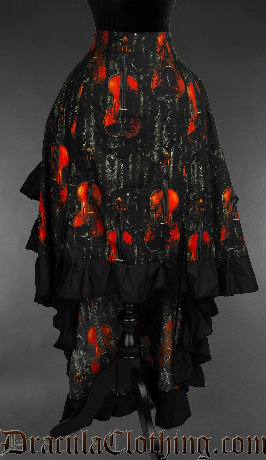 Front view of women's violin print layered black bustle skirt showing the skirt lowered in front