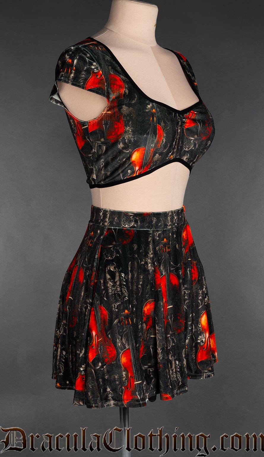Side view of women's velvet crop top with dark background colour and printed violin design