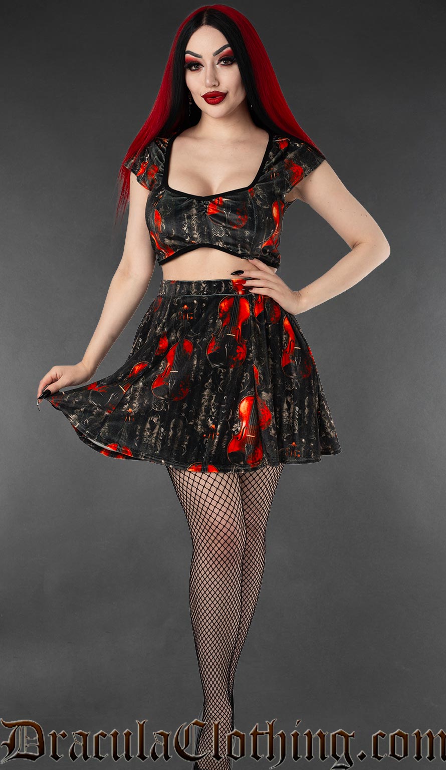 Women's velvet crop top and separate skirt with printed violin design on black background shown on model