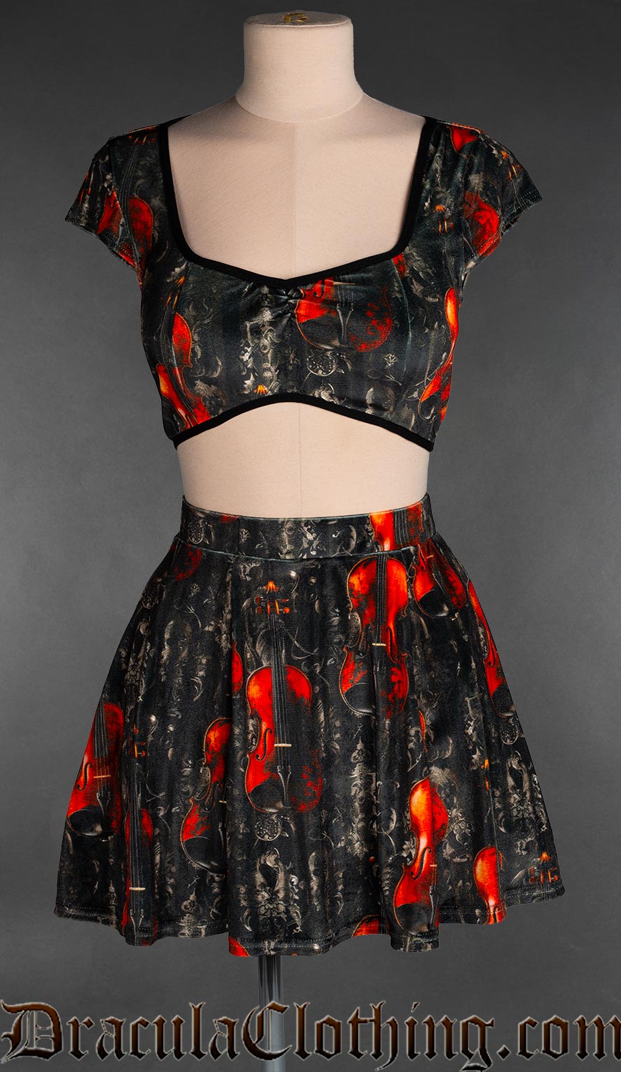 Women's velvet short skirt with printed violin design on a black background shown with matching crop top