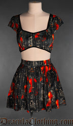 Women's velvet short skirt with printed violin design on a black background shown with matching crop top
