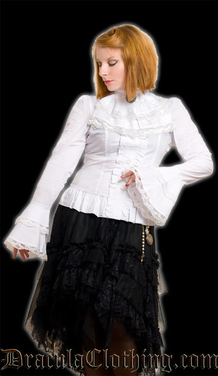 White cravat shirt worn by model showing layered flared sleeve cuffs with lace trim and gathered trim button placket as well as a frilled hem and slightly puffed shoulders