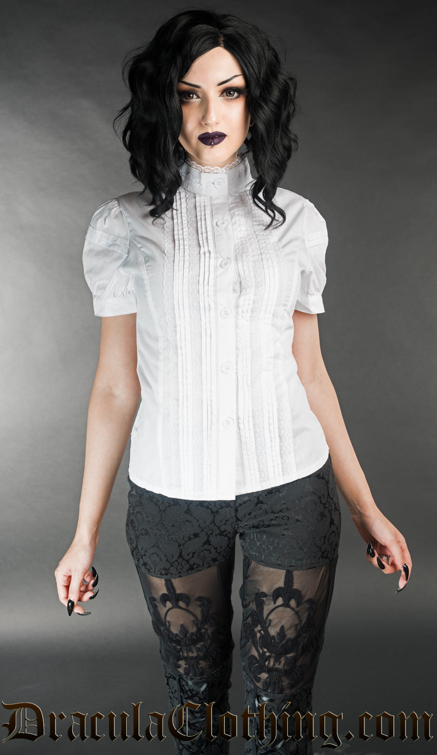 Model wearing white edwardian blouse with puffed short sleeves and high neck collar