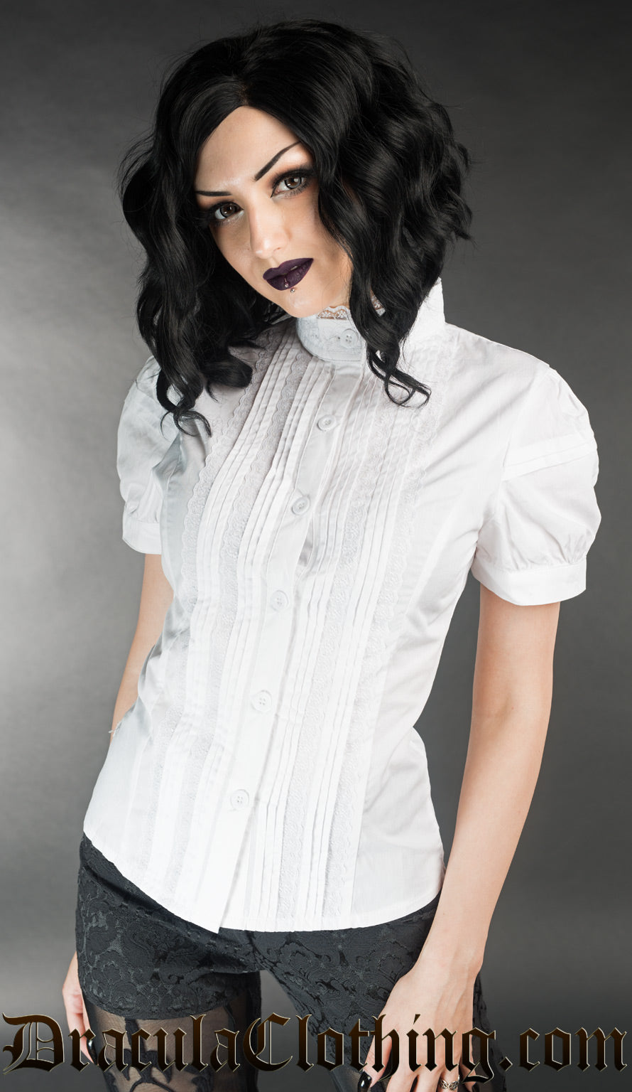 Model wearing womens white cotton blouse with short puffed sleeves and pleated design on the front