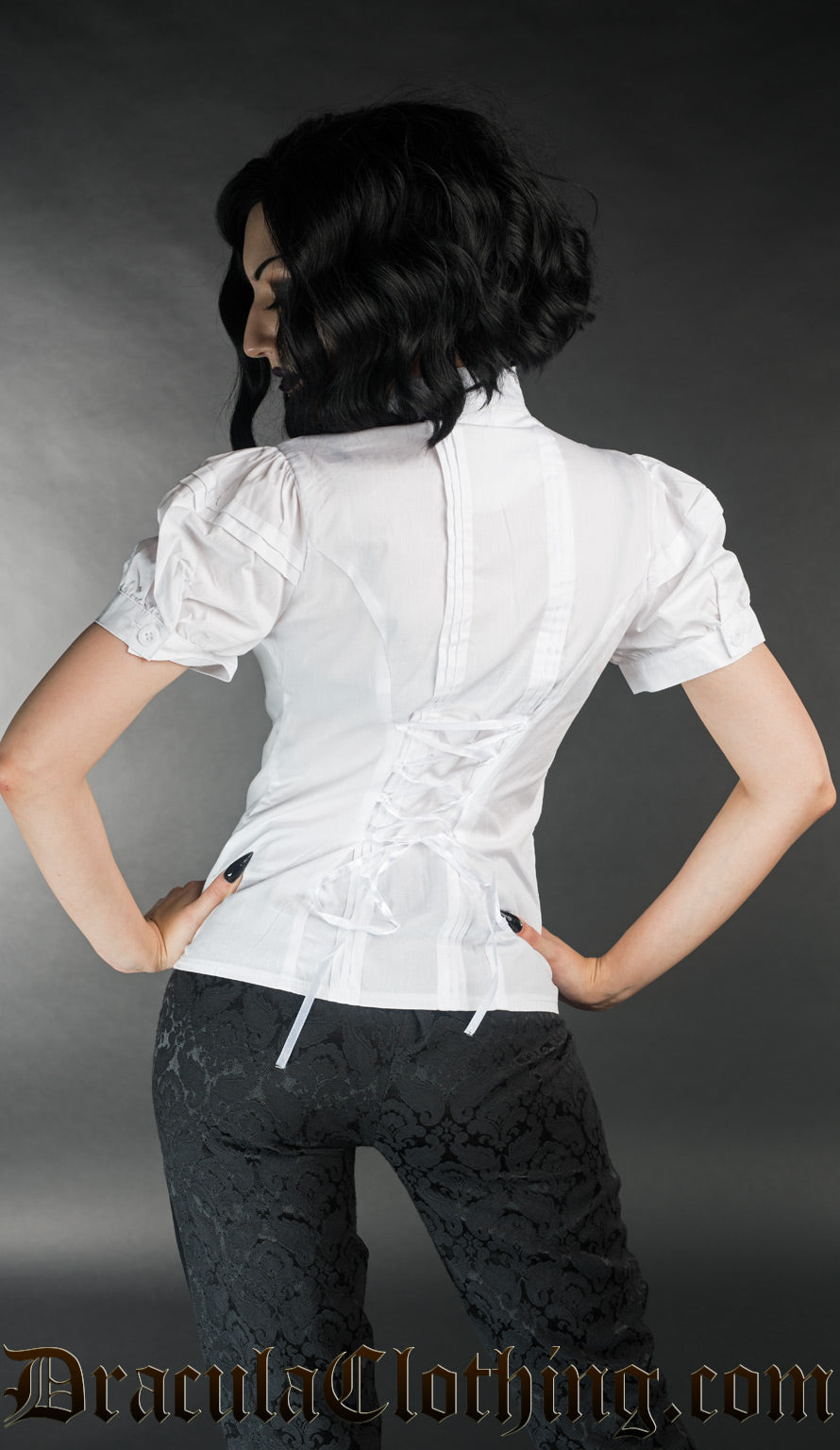 Model showing back of white edwardian blouse showing pleat detail and adjustable lacing