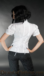 Model showing back of white edwardian blouse showing pleat detail and adjustable lacing