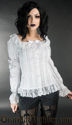 Model wearing long sleeved cotton blouse with frilly lace details and bows