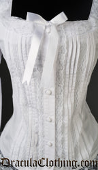 Close up of front of women's white blouse showing pleated design and lace details 