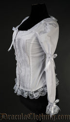 Side view of white blouse showing elastic in the long sleeves and ribbon bow details