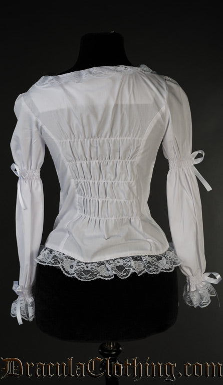 Back view of women's white blouse showing elasticated back panel for fitted style and lace hem trim